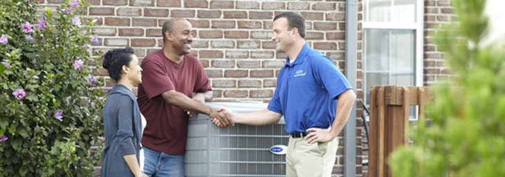 Carrier dealer providing homeowners with advice about heat pumps.